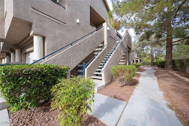 View of side of property with stairs and stucco siding