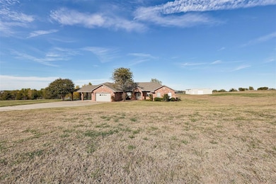 View of front of property with driveway, a garage,