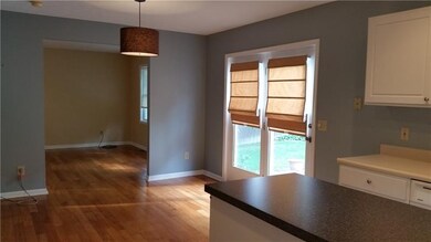 View of Kitchen into Living Room.  Doors lead to y