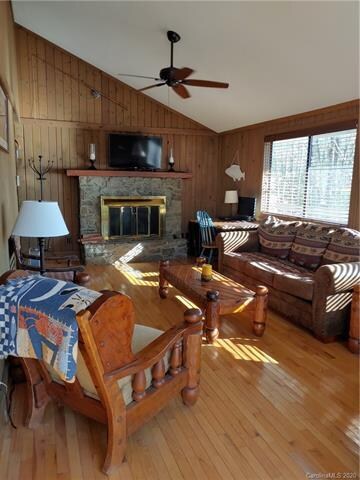 Great Room with vaulted ceiling and stone fireplac