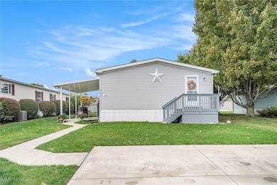 View of front of house featuring a front yard and a deck
