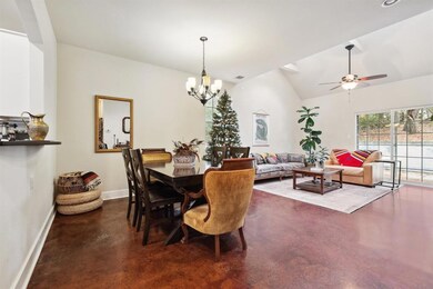 Dining area featuring concrete floors, ceiling fa