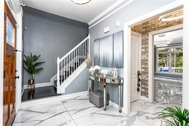 Foyer entrance featuring baseboards, a notable cha
