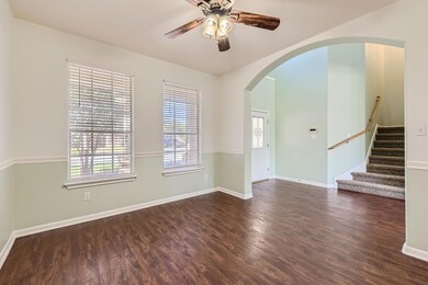 Unfurnished room with a ceiling fan, wood finishe