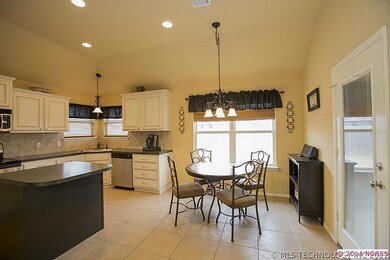 Breakfast room and kitchen with door leading to Fl