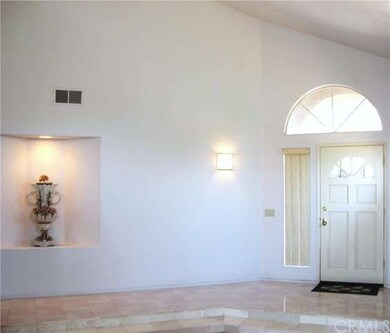 Dramatic entrance with marble flooring and high ce