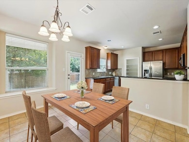 Dining room with a chandelier, light tile pattern