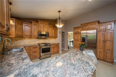 The kitchen includes under cabinet lighting, grani