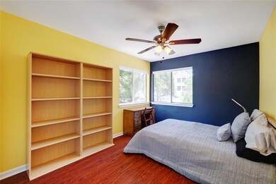 Bedroom with wood finished floors and a ceiling f