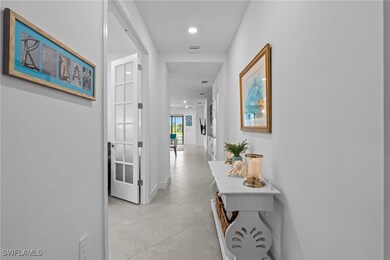 Corridor with light tile patterned flooring, baseb