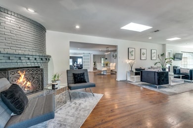 Living room with hardwood / wood-style flooring, a