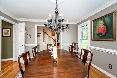 Dining room with a notable chandelier, crown moldi