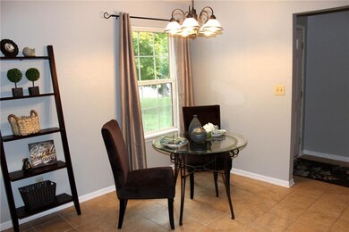 The entry opens into the eat in kitchen which also boasts tiled flooring plus updated light fixture over in the eat in area.  This is a spacious kitchen and can accommodate a table for 2,4,6 or whatever you desire. 