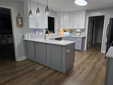 Kitchen featuring freestanding refrigerator, backs