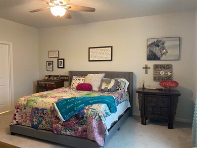 Bedroom featuring ceiling fan and carpet flooring