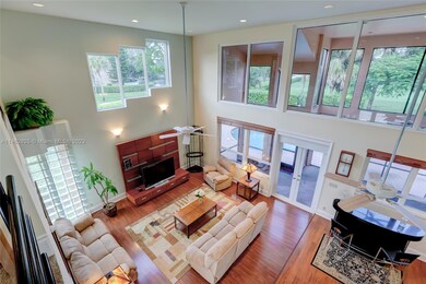 Impressive Family Room w/ Volume Ceiling and Tons of Natural Light / Windows & High Hat lighting for entertaining w/ French Doors to Patio