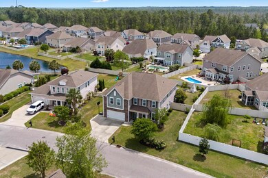 Birds eye view of property with a view of trees and a residential view