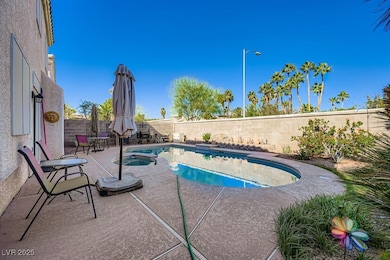 View of pool with a fenced backyard, a patio, and a pool with connected hot tub