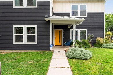 View of exterior entry featuring a lawn