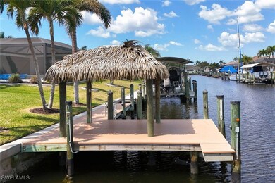View of dock with a lawn, a water view. Fish from