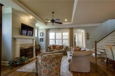 The living room is open to the kitchen and dining area and has a wood burning fireplace.