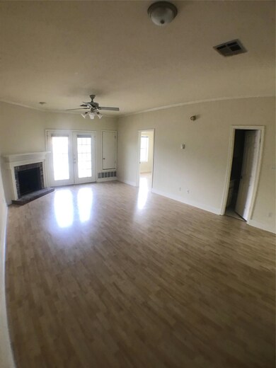 Unfurnished living room with a fireplace with rai