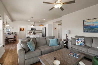 Living area featuring wood finished floors, recessed lighting, and a ceiling fan