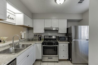 Kitchen featuring white cabinets, under cabinet ra