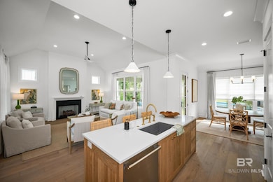 Kitchen with pendant lighting, dishwasher, brown cabinets, light wood finished floors, and open floor plan
