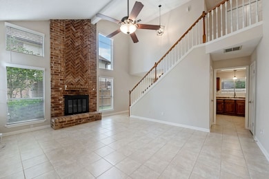 Living room has high ceilings, fireplace, and tile