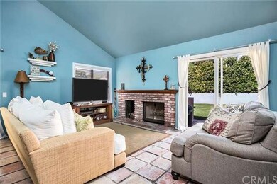 Family room with brick fireplace and wood storage.