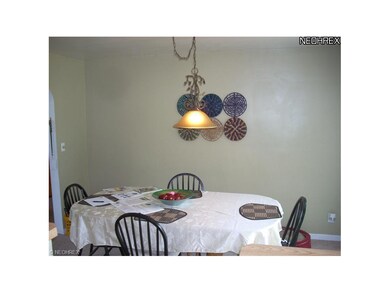Spacious and airy formal dining room has full wall