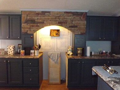 Kitchen with stone counters, ornamental molding, a