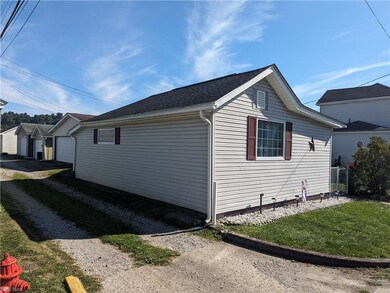 View of side of property featuring garage and a la