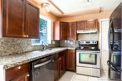Kitchen with granite countertops and all wood cabi