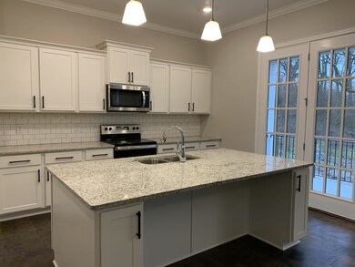 Glass door leading to covered patio and steps to back yard