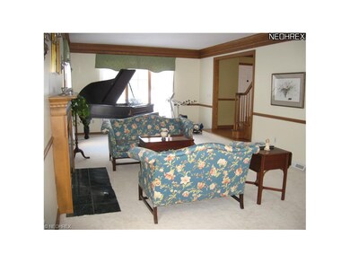 Deep crown moulding and chair rail enhance the adj
