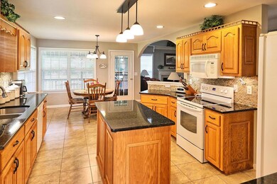 Kitchen features granite counters and center island for convenient work space. 
