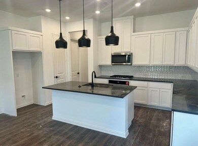 Kitchen featuring dark hardwood / wood-style flooring, tasteful backsplash, white cabinets, sink, and appliances with stainless steel finishes