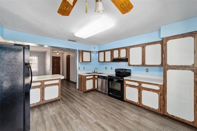Kitchen with View of Front Door and Living Room