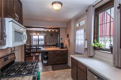 Open floor plan to dining room.  NOTE: gas, stainless steel stove.