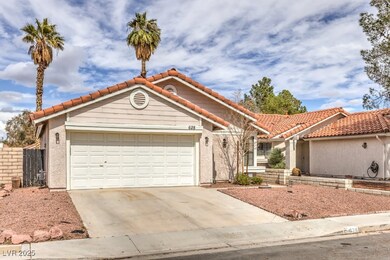 View of front facade with concrete driveway, a til
