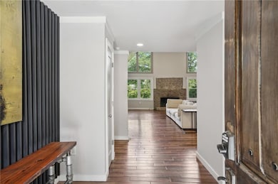 Entryway with dark wood finished floors, baseboard