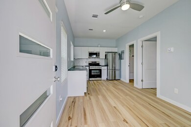 Step inside to a large kitchen and living area with vinyl plank floors, current finishes, and is filled with natural light.