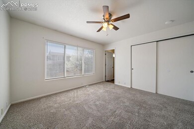 Unfurnished bedroom with carpet floors, baseboards, a ceiling fan, and a closet