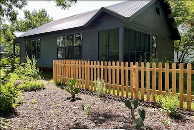 View of side of property featuring a metal roof