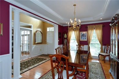 The two story foyer and dining room offer hardwood