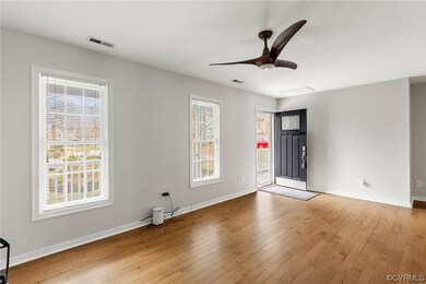 Empty room with hardwood / wood-style floors and c