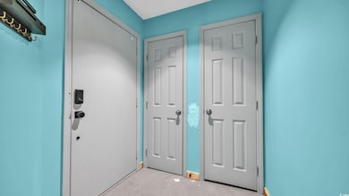Foyer featuring light carpet