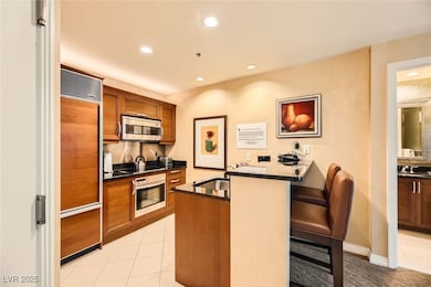Kitchen with stainless steel appliances, dark coun